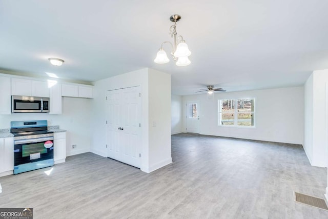 541 Day Star Ln, Mount Airy, GA 30563 - kitchen featuring appliances with stainless steel finishes, white cabinetry, a chandelier, light wood finished floors, and a ceiling fan