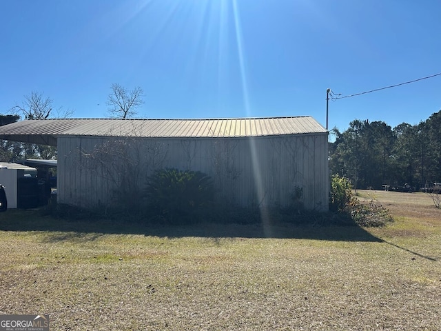 194 Lower Brookfield Rd, Tifton, GA 31794 - view of home's exterior with a lawn, an outdoor structure, and metal roof
