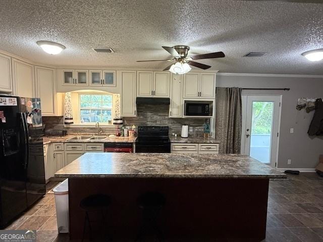 194 Lower Brookfield Rd, Tifton, GA 31794 - kitchen featuring black appliances, a sink, backsplash, a kitchen island, and ceiling fan