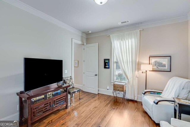 2189 Bessbrook Sq, Statham, GA 30666 - living area with ornamental molding, wood finished floors, and baseboards