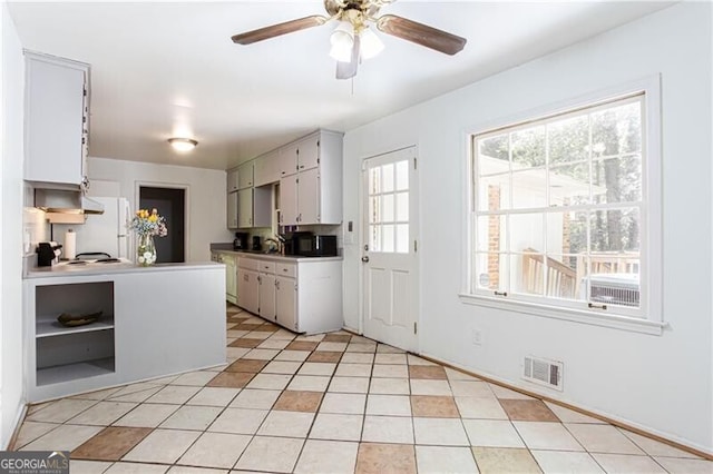 2620 Clairmont Rd, Atlanta, GA 30329 - kitchen with freestanding refrigerator, open shelves, a ceiling fan, and light countertops