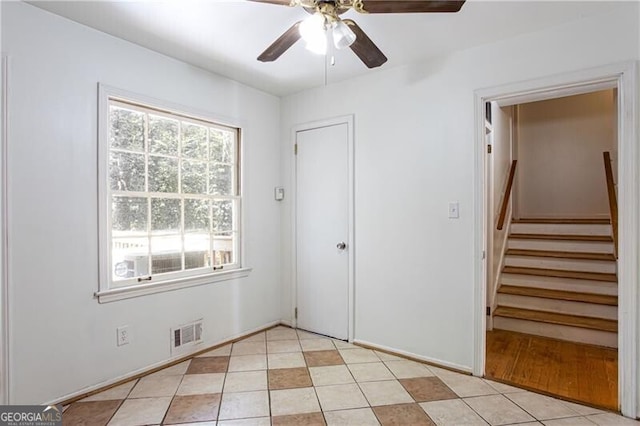 2620 Clairmont Rd, Atlanta, GA 30329 - spare room featuring a ceiling fan, light tile patterned floors, and stairs