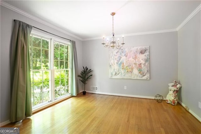 2620 Clairmont Rd, Atlanta, GA 30329 - empty room featuring a chandelier, wood finished floors, crown molding, and baseboards