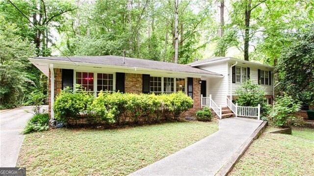 2620 Clairmont Rd, Atlanta, GA 30329 - tri-level home featuring brick siding and a front yard