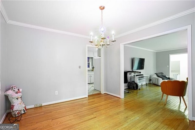2620 Clairmont Rd, Atlanta, GA 30329 - dining space with a chandelier, light wood finished floors, baseboards, and crown molding