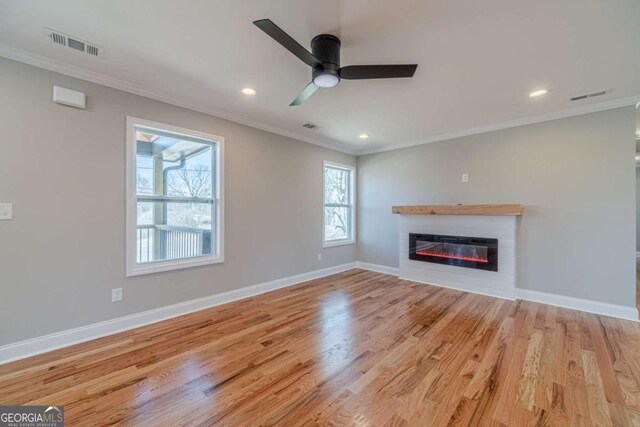 2741 Pierce Rd, Gainesville, GA 30507 - unfurnished living room with crown molding, a glass covered fireplace, baseboards, wood finished floors, and recessed lighting