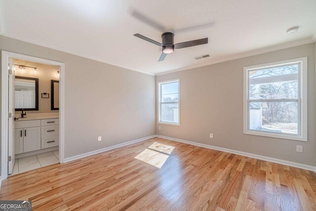 2741 Pierce Rd, Gainesville, GA 30507 - unfurnished bedroom featuring ornamental molding, light wood-type flooring, baseboards, and a sink