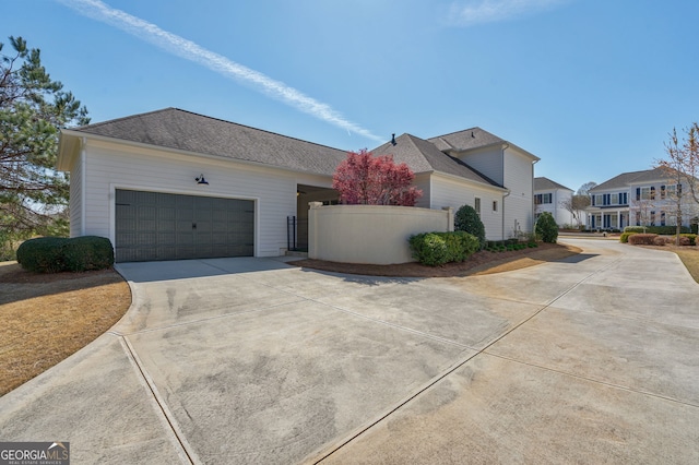 2970 Greenleffe Dr, Statham, GA 30666 - view of front facade featuring concrete driveway, an attached garage, fence, and a residential view