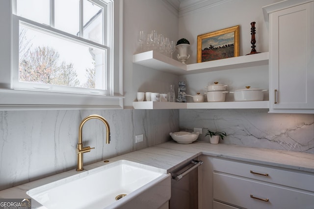 2970 Greenleffe Dr, Statham, GA 30666 - detailed view of open shelves, a sink, decorative backsplash, light stone countertops, and white cabinetry