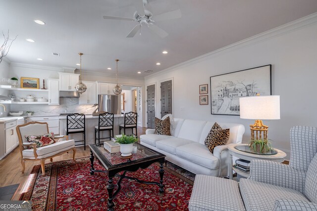 2970 Greenleffe Dr, Statham, GA 30666 - living area featuring light wood finished floors, crown molding, recessed lighting, and ceiling fan