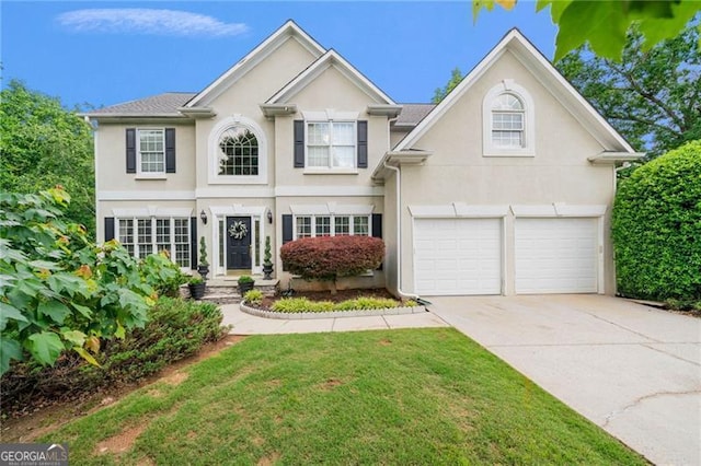 traditional-style home featuring driveway, a garage, stucco siding, and a front lawn
