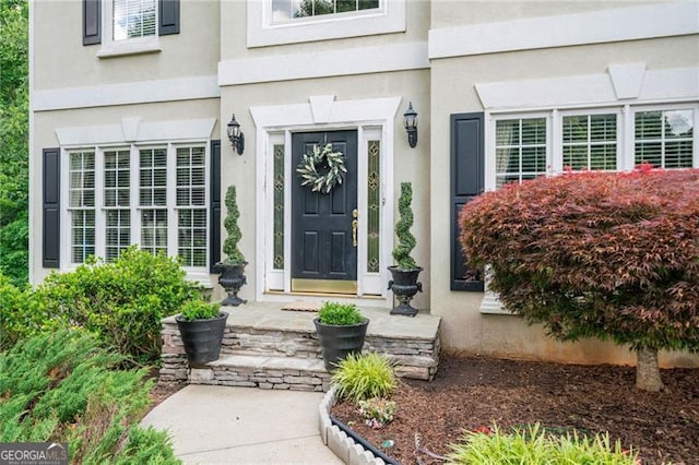 entrance to property with stucco siding