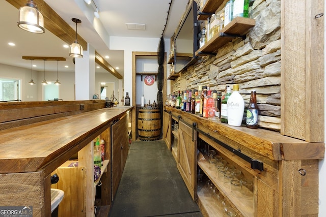 indoor bar featuring hanging light fixtures and recessed lighting