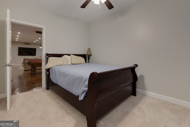bedroom with light carpet, baseboards, and ceiling fan