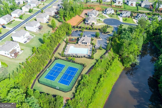 aerial view of residential area featuring a large body of water