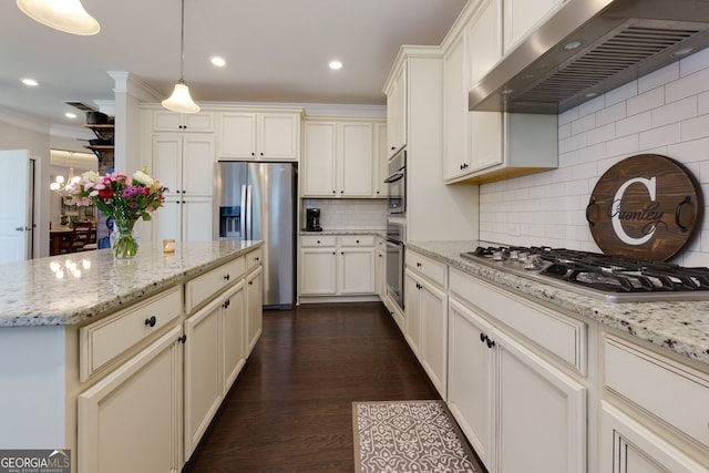 kitchen with extractor fan, stainless steel appliances, decorative backsplash, decorative light fixtures, and light stone countertops