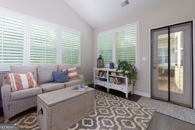 living room with lofted ceiling, wood finished floors, and baseboards