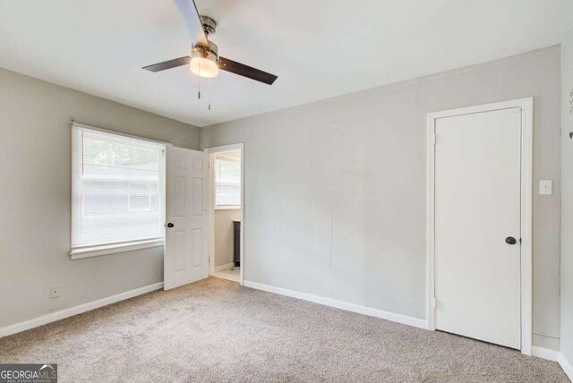 2564 Riggs Dr, East Point, GA 30344 - unfurnished bedroom with carpet flooring and a ceiling fan
