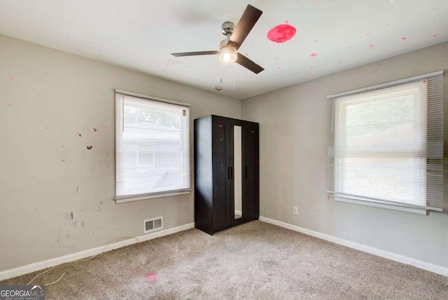 2564 Riggs Dr, East Point, GA 30344 - unfurnished bedroom with multiple windows, carpet, and ceiling fan