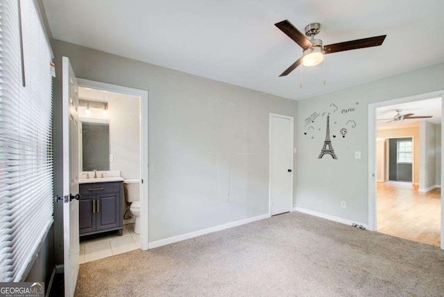 2564 Riggs Dr, East Point, GA 30344 - unfurnished bedroom featuring light colored carpet, ensuite bathroom, and a ceiling fan