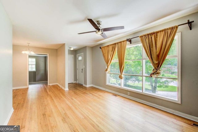 2564 Riggs Dr, East Point, GA 30344 - unfurnished living room featuring wood finished floors, a chandelier, and ceiling fan