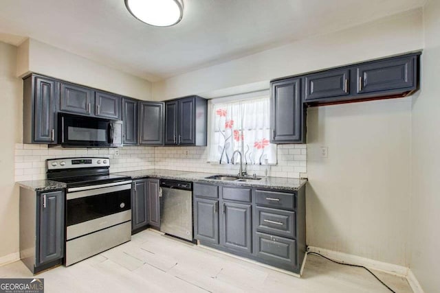 2564 Riggs Dr, East Point, GA 30344 - kitchen with appliances with stainless steel finishes, stone counters, backsplash, and gray cabinetry