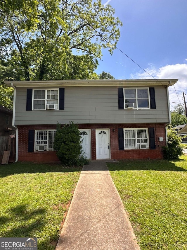 2872 Harris St, Atlanta, GA 30344 - colonial house with a front yard, brick siding, and cooling unit