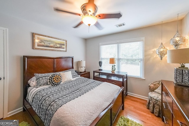4135 Creekwood Dr, Cumming, GA 30041 - bedroom with light wood finished floors, baseboards, and ceiling fan