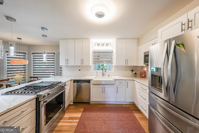 4135 Creekwood Dr, Cumming, GA 30041 - kitchen with appliances with stainless steel finishes, a sink, plenty of natural light, and decorative backsplash