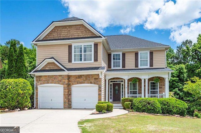 40 Boulder Ct, Dallas, GA 30132 - view of front of house with driveway, a garage, a porch, stone siding, and a front lawn