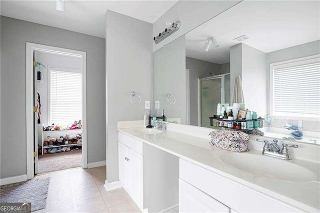 40 Boulder Ct, Dallas, GA 30132 - full bath featuring a stall shower, double vanity, baseboards, and tile patterned flooring