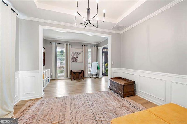 40 Boulder Ct, Dallas, GA 30132 - entrance foyer with a chandelier, wood finished floors, a wainscoted wall, a decorative wall, and a raised ceiling