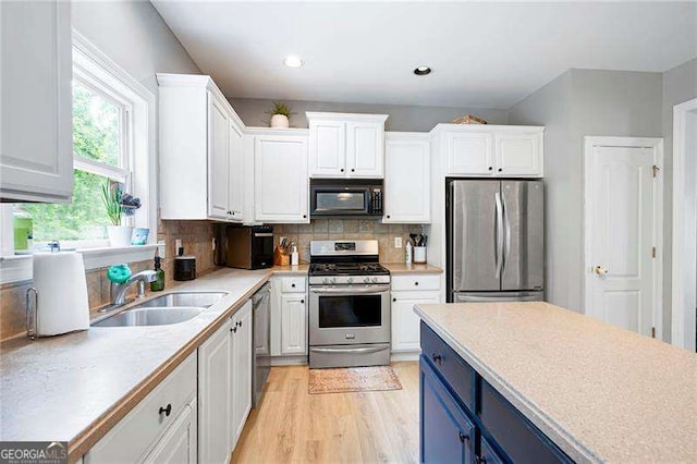 40 Boulder Ct, Dallas, GA 30132 - kitchen featuring stainless steel appliances, a sink, blue cabinets, white cabinets, and recessed lighting