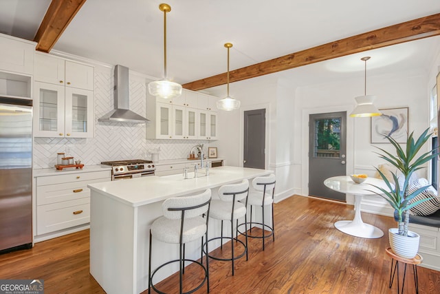 1231 Mansfield Ave NE, Atlanta, GA 30307 - kitchen featuring wall chimney range hood, stainless steel appliances, beamed ceiling, decorative backsplash, and light countertops