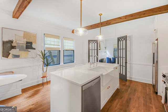 1231 Mansfield Ave NE, Atlanta, GA 30307 - kitchen featuring stainless steel dishwasher, beam ceiling, wood finished floors, pendant lighting, and light countertops