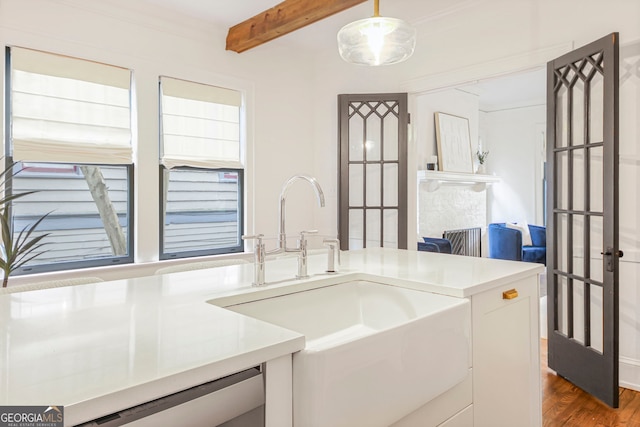 1231 Mansfield Ave NE, Atlanta, GA 30307 - kitchen featuring dishwashing machine, wood finished floors, beamed ceiling, light countertops, and hanging light fixtures