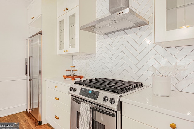 1231 Mansfield Ave NE, Atlanta, GA 30307 - kitchen with ventilation hood, gas range, high end fridge, light countertops, and tasteful backsplash