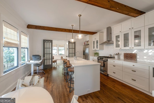 1231 Mansfield Ave NE, Atlanta, GA 30307 - kitchen featuring wall chimney exhaust hood, stainless steel appliances, a sink, beamed ceiling, and backsplash