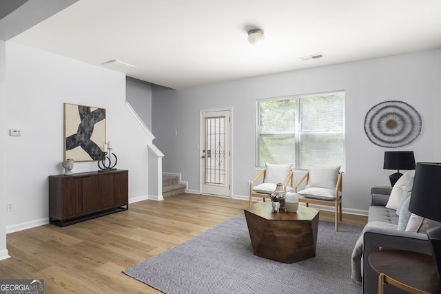 4457 Watson Ridge Dr, Stone Mountain, GA 30083 - living room featuring stairs, light wood-style flooring, and baseboards