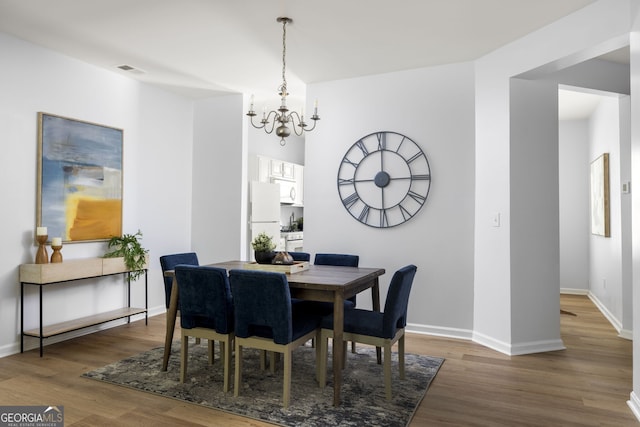 4457 Watson Ridge Dr, Stone Mountain, GA 30083 - dining area featuring a chandelier, wood finished floors, and baseboards