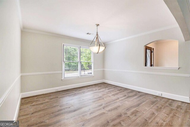 703 Kirkwood Cir, Woodstock, GA 30189 - unfurnished room with wood finished floors, baseboards, ornamental molding, and arched walkways