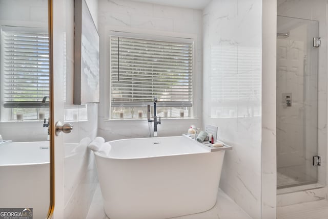565 Barsham Way, Johns Creek, GA 30097 - bathroom featuring a marble finish shower, healthy amount of natural light, a freestanding bath, and tile walls