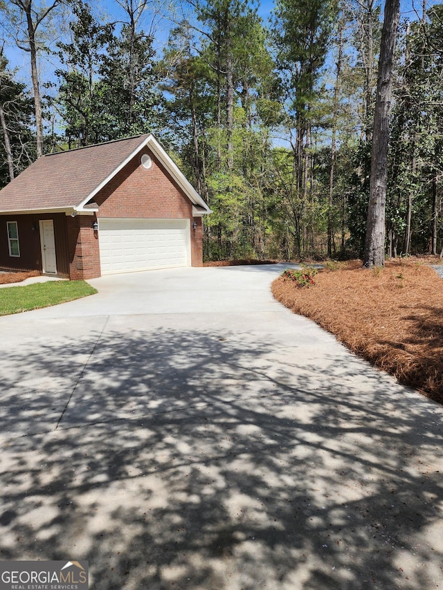 213 Falcon Crst, Warner Robins, GA 31088 - view of front of home featuring brick siding, driveway, an attached garage, and a shingled roof