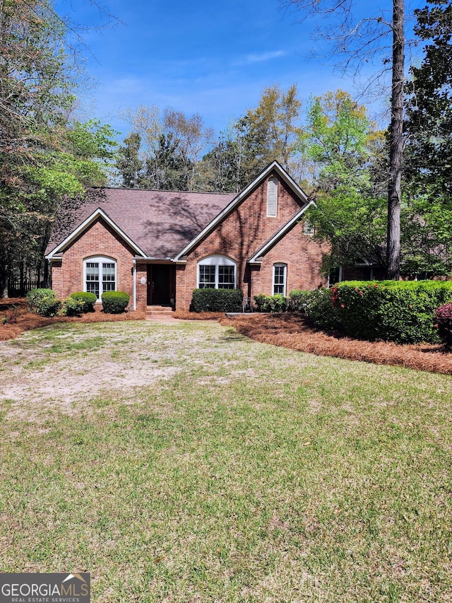 213 Falcon Crst, Warner Robins, GA 31088 - view of front of house with a front yard and brick siding