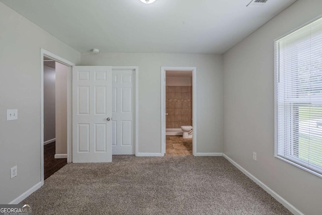 1808 Arkose Dr SE, Atlanta, GA 30316 - unfurnished bedroom featuring multiple windows, carpet flooring, baseboards, and ensuite bath