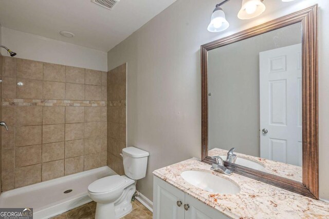 1808 Arkose Dr SE, Atlanta, GA 30316 - bathroom with a tile shower, vanity, toilet, and baseboards