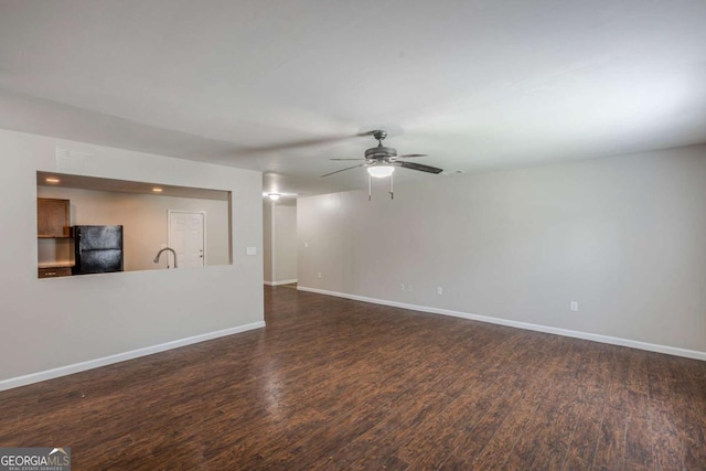 1808 Arkose Dr SE, Atlanta, GA 30316 - unfurnished living room with dark wood-type flooring, a ceiling fan, baseboards, and a sink