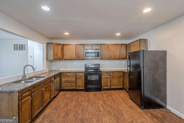 1808 Arkose Dr SE, Atlanta, GA 30316 - kitchen with black appliances, a sink, dark wood-type flooring, a peninsula, and brown cabinetry