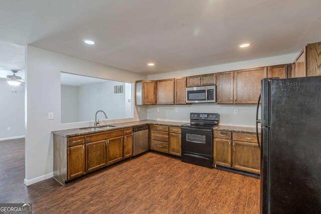 1808 Arkose Dr SE, Atlanta, GA 30316 - kitchen with black appliances, a sink, dark wood finished floors, brown cabinetry, and recessed lighting