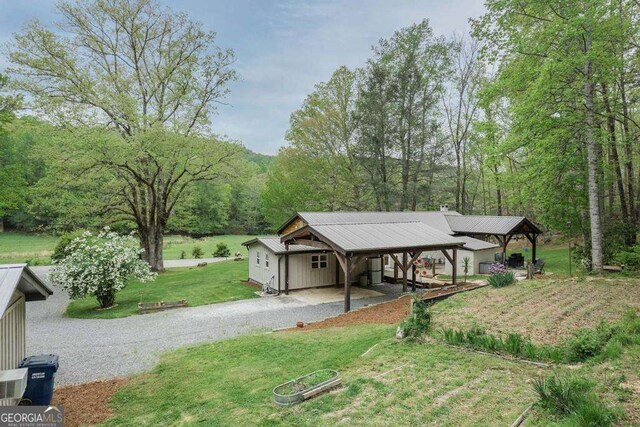 18131 Morganton Hwy, Morganton, GA 30560 - view of front of home featuring board and batten siding, a front lawn, a chimney, and entry steps